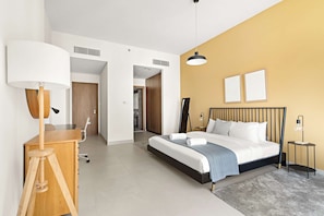 A modern bedroom with a bed, bedside tables, a desk, and a lamp. - Silkhaus Elite 2bdr With Canal View in Al Wasl (Dubai)