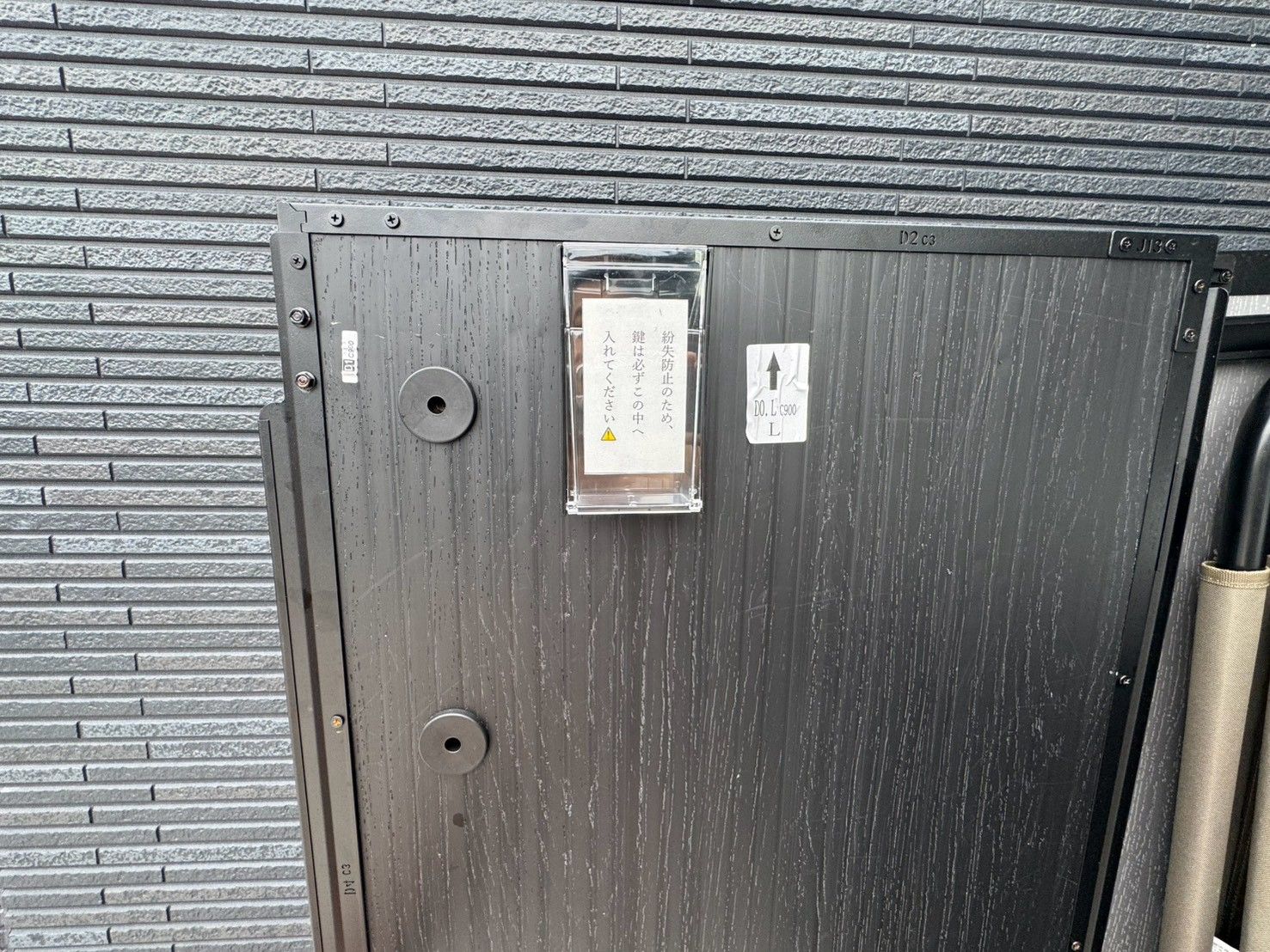 A metal door with a warning sign and a label indicating a fire safety measure.