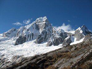 A snow-covered mountain range with rugged peaks and a clear sky.