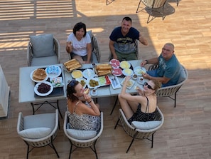 A group of people seated around a table with various food items and drinks. - GEM View grand Boutique (Giza)