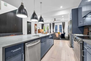 A modern kitchen with a dishwasher, double sink, and a built-in oven. - Southern Souls 715-Downtown Nearby-Sleeps 6 (Nashville)
