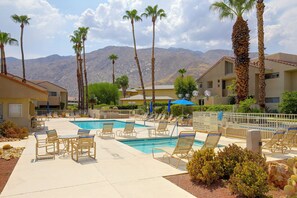 A pool area with lounge chairs, palm trees, and a mountain backdrop. - Unwind Poolside, Walk Dtwn! Palm Springs Retreat (Palm Springs)