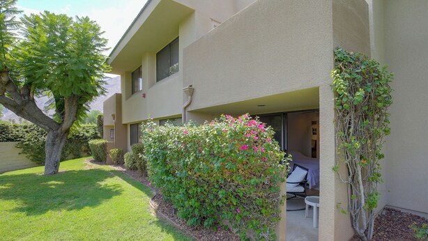 A two-story building with a covered outdoor seating area, a small garden, and a view of the mountains. - Unwind Poolside, Walk Dtwn! Palm Springs Retreat (Palm Springs)