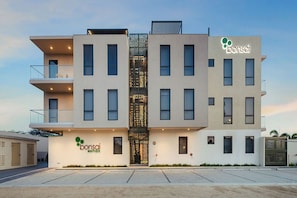 A modern building with a central entrance, multiple balconies, and a sign for 'bonsai.' - Bonsai Studio-Airy 202 (Noord)