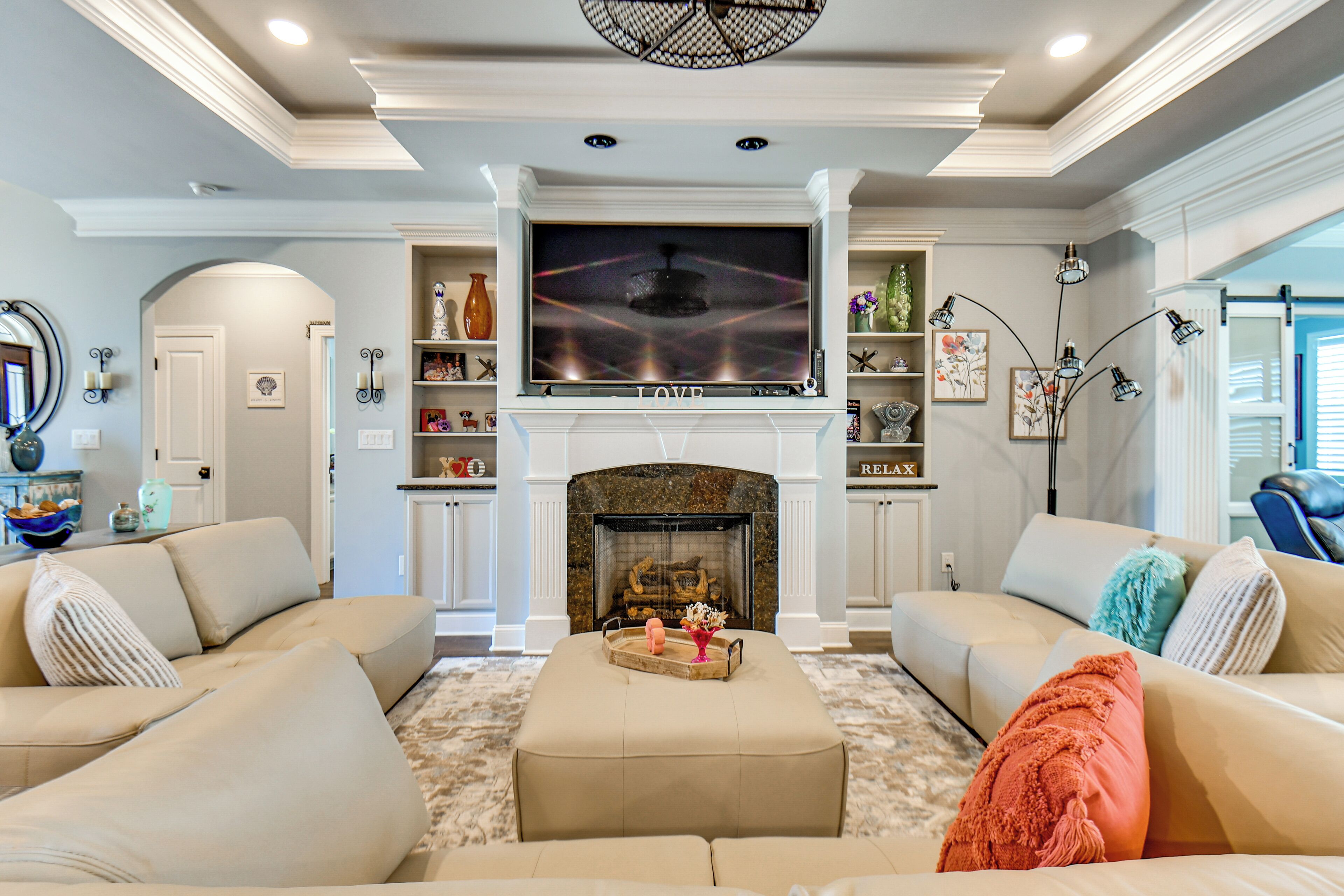 A living room with a fireplace, a television, and a sofa.