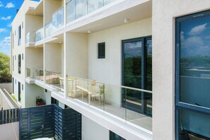 A multi-story residential building with balconies, large windows, and a flat facade. - Bonsai 2BR Retreat-Midori 210 (Noord)