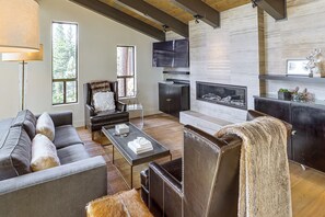 A modern living room with a fireplace, leather furniture, and a television. - Stunning Lake & Mtn Views! Cb/incline Village Home (Incline Village)