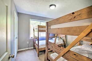A bunk bed room with a window, a door, and a ceiling light fixture. - Amazing views, hot tub, foosball! (McGaheysville)