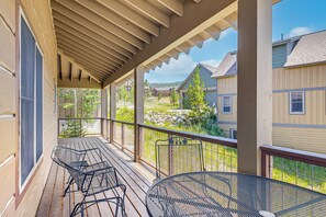 A covered outdoor area with wooden flooring, metal chairs, and tables. - Hike, Bike & Ski! Rendezvous Cabin w/ Mtn Views (Fraser)