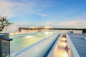 A rooftop swimming pool with a clear view of the city skyline in the background. - Bonsai 2BR Retreat-Red Bloom 310 (Noord)