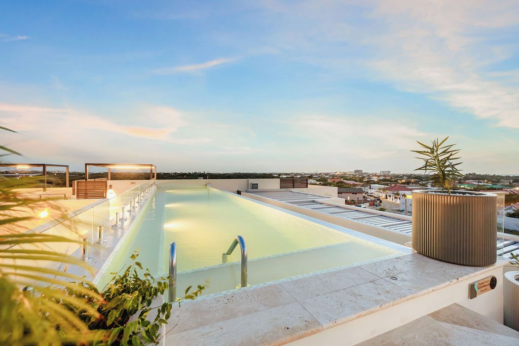 Ein Pool auf dem Dach mit freiem Blick auf die Skyline im Hintergrund.