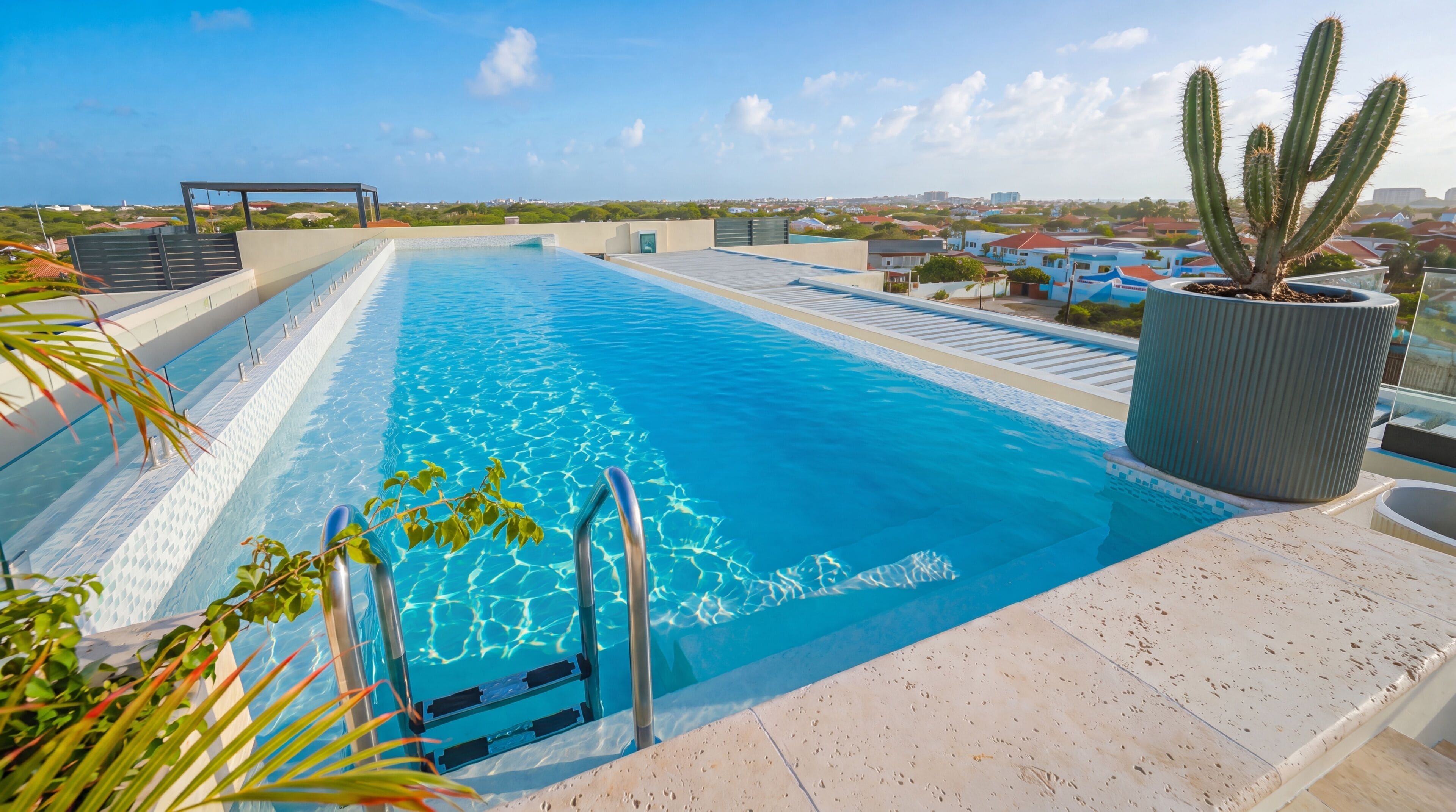 A rooftop pool with clear blue water, surrounded by a modern architectural setting.