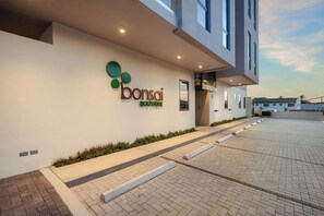 A modern building with a sign for 'bonsai boutique' on the exterior wall. - Bonsai 2BR Retreat-Sora 311 (Noord)
