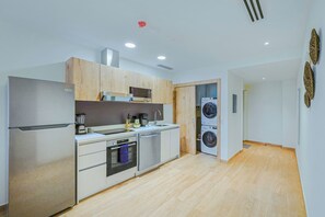 A modern kitchen with a built-in oven, microwave, and dishwasher. - Bonsai 3BR Retreat Grand 307 (Noord)