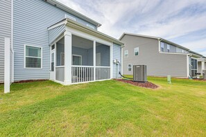 A row of single-story homes with attached porches and a well-maintained lawn.