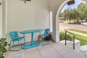 A patio with a table and chairs, a view of the street, and a railing. - Walk to Gulfport Beach! Quiet Home w/ Yard (Gulfport)