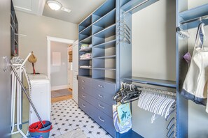 A walk-in closet with multiple shelves and drawers, a drying rack, and a hanging area for clothes. - Walk to Gulfport Beach! Quiet Home w/ Yard (Gulfport)