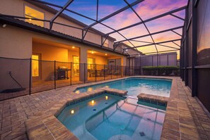 Ein Pool mit Whirlpool, umgeben von einer überdachten Terrasse mit Sitzgelegenheiten.
