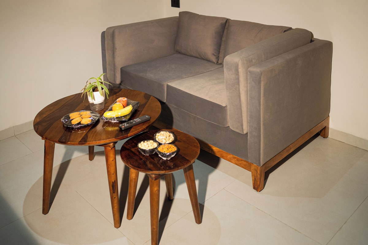 A living room with a sofa, a coffee table, and a small side table.