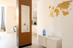 A modern interior with a wooden partition, a white console table, and a world map on the wall. - ALL Spa and Relax | Mediterranean Retreat (Monopoli)