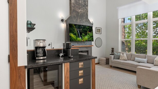 A modern kitchen with a coffee maker, espresso machine, and a large flat-screen TV. - Big Island Waikoloa Colony Villas 2303 2 Bedroom Condo (Waikoloa)