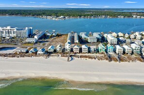 Une zone côtière comprenant des propriétés situées en bord de mer, un port de plaisance et un grand complexe hôtelier.