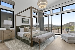 A spacious bedroom with a four-poster bed, large windows, and a view of the countryside. - Mtn Retreat w/ Hot Tub, Game Room & Lake Views (Heber City)