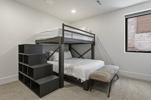 A bunk bed with a desk and shelving unit in a room with a window. - Mtn Retreat w/ Hot Tub, Game Room & Lake Views (Heber City)