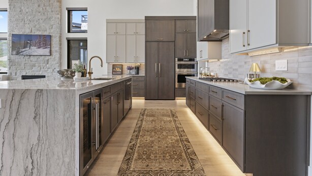 A modern kitchen with marble countertops, dark cabinetry, and a central island. - Mtn Retreat w/ Hot Tub, Game Room & Lake Views (Heber City)