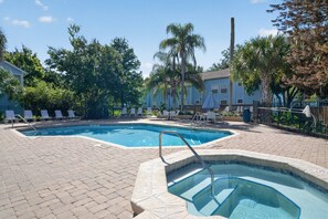 A swimming pool area with two pools, lounge chairs, and a hot tub. - your Happy Place Close To All The Magic! 3 Bedroom Condo (Kissimmee)