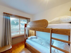 A bunk bed room with a window overlooking a residential area. - Apartment Allod 510 by Interhome (St. Moritz)