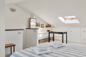 A bedroom with a skylight, a bed with towels, a desk, and a chair. - [RoadToTheSea]Lerici/Private parking /terrace (Lerici)