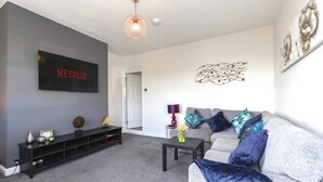 A living room with a flat-screen TV, a sofa, a coffee table, and decorative items. - The Waltons – Ideal Durham Escape - Nature Lovers - Pass the Keys (New Brancepeth)
