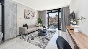 A modern living room with a sofa, coffee table, and artwork on the wall. - The Paramount | Contemporary Luxury (Johannesburg)