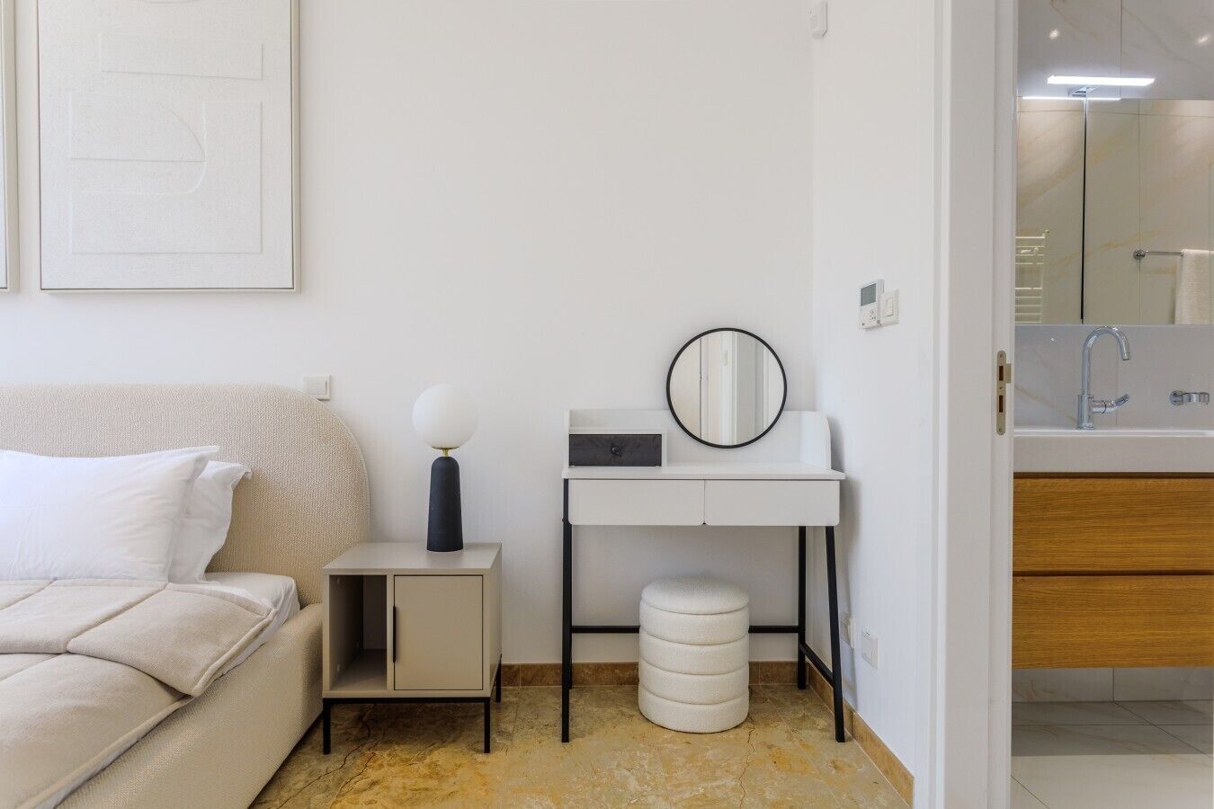 A modern bathroom with a glass shower enclosure, a white sink, and a mirror.