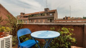 A blue chair and table on a rooftop terrace with a view of residential buildings. - Cozy 45 sqm flat, perfect for 3 people, located on the 5th floor of a building with elevator.The property is situated in the Calvairate district, a residential area characterized by the green spaces of Piazza Insubria & Viale Molise.The Porta Romana dist (Milan)
