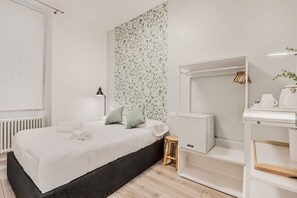 A modern bedroom with a bed, a small stool, a white wardrobe, and a radiator. - [RoomsCamera1] 5Terre-Near the station+A/C (La Spezia)
