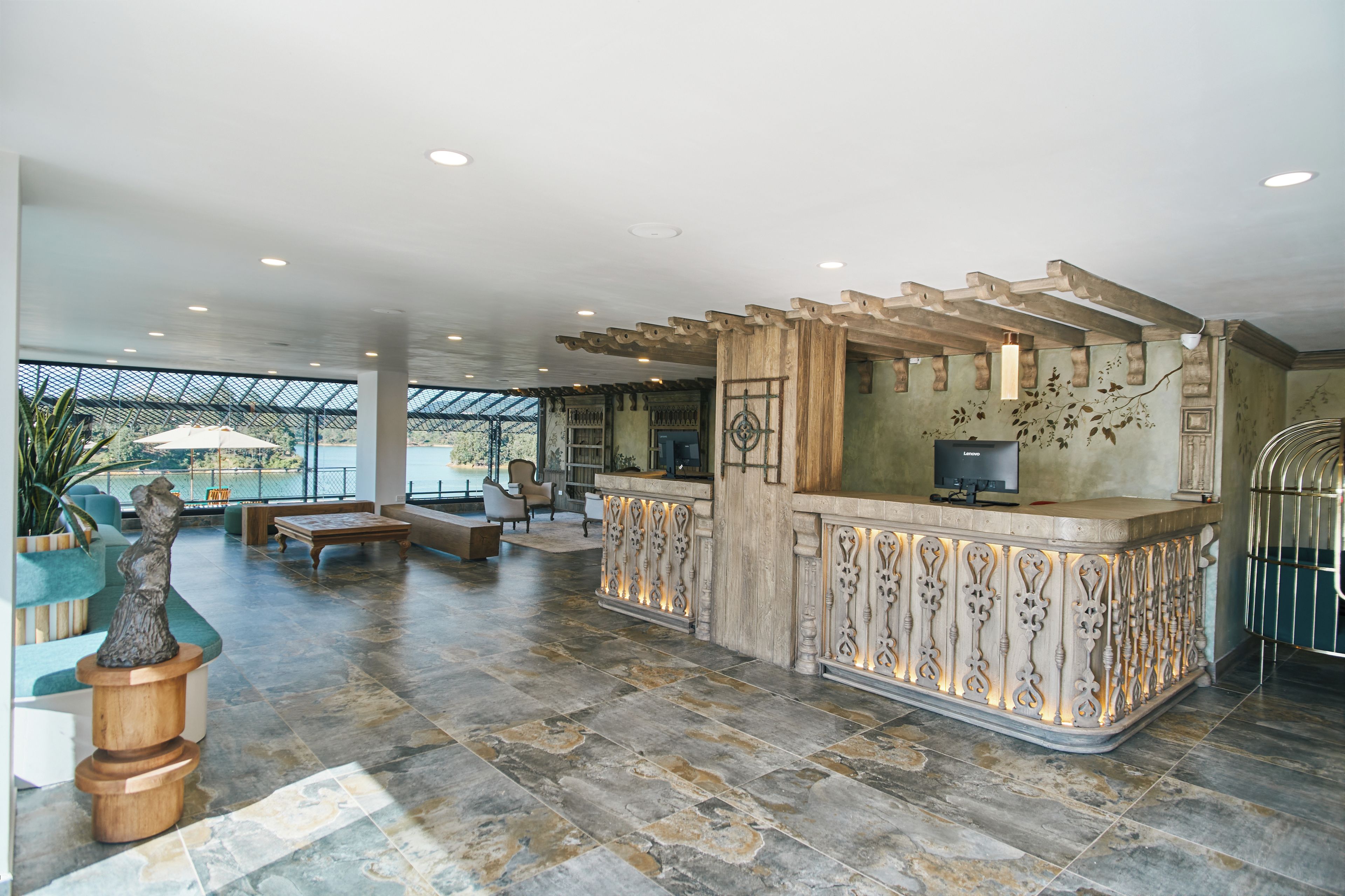 A spacious lobby with a reception desk, seating area, and a view of the outdoors.