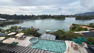 Outdoor pool, open 9:00 AM to 9:00 PM, pool umbrellas, pool loungers