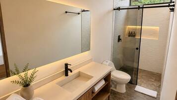 Separate bathtub and shower, towels, soap, shampoo