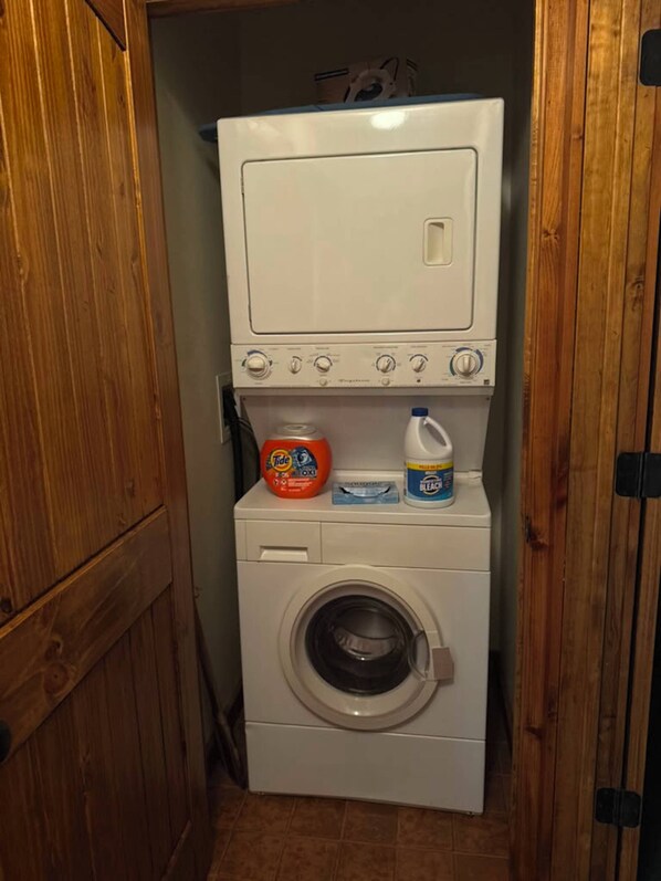 A compact laundry room with a front-loading washing machine and a dryer.