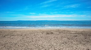 A beach with a clear sky and calm sea. - Lux Coastal Retreat • Steps to Sand• Heated Pool by Maera (Carpinteria)