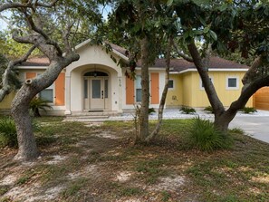 A residential building with a beige facade, a single entrance door, and a number '416' on the wall. - Fully Renovated Beach Retreat in Sunnyside (Panama City Beach)
