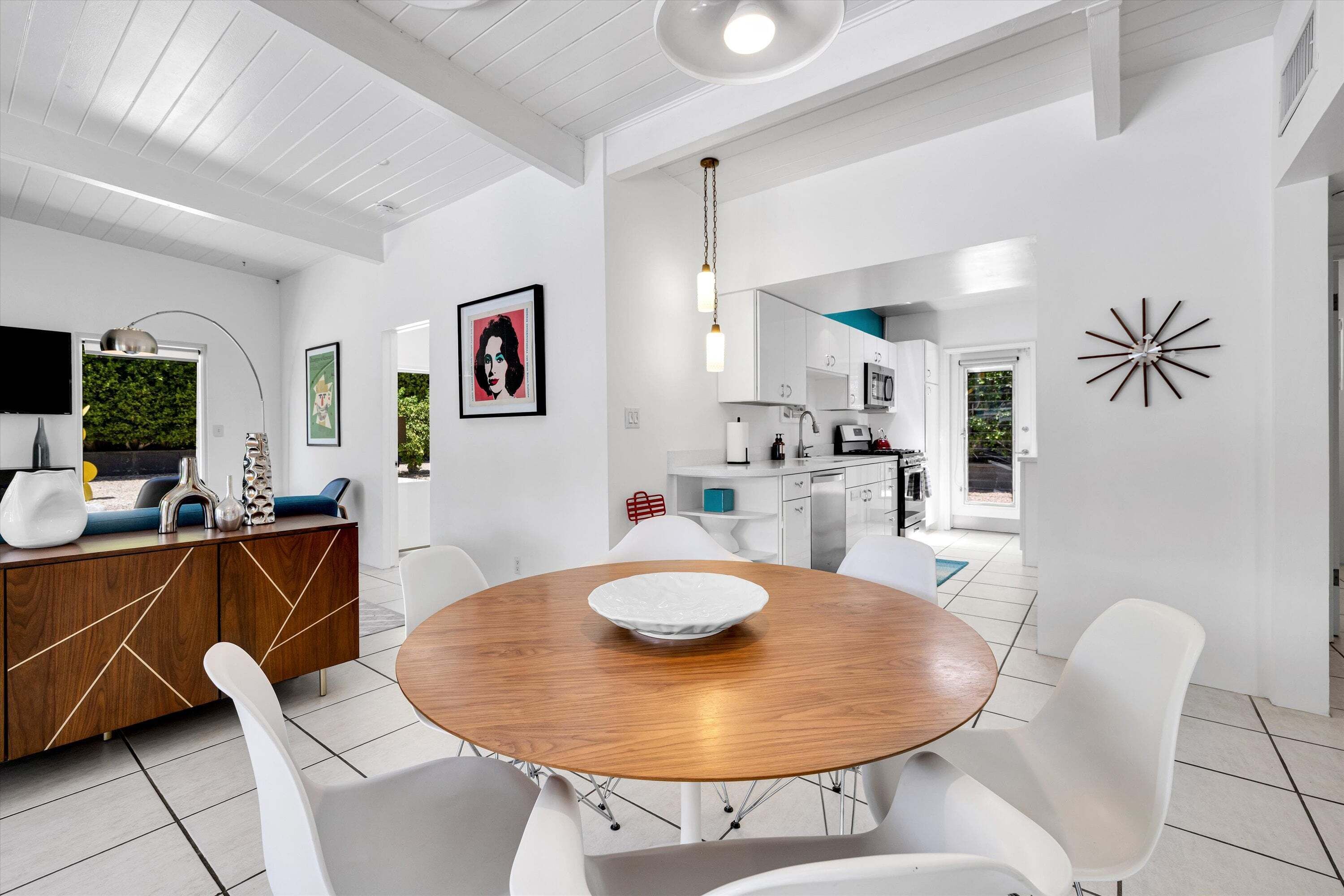 A modern kitchen with white cabinets, a microwave, and a stove.