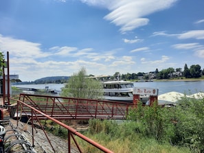 A river with boats, a bridge, and a sign reading 'Alte Liebe.'