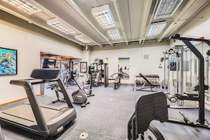 A gym with treadmills, elliptical machines, and weightlifting equipment. - 2 Studios Steps to Lift | Pool, Hot Tubs & Slopes (Breckenridge)