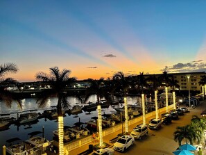 A marina with boats docked, a waterfront promenade, and a building in the background. - Spacious 3-bedroom condo in lovely Naples with fitness room (Naples)