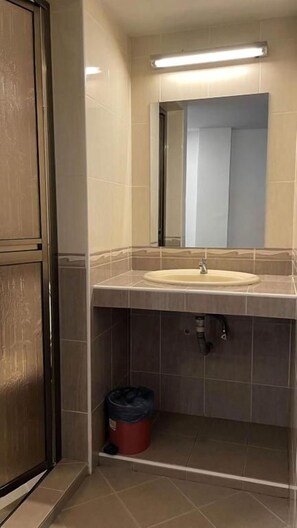 A bathroom with a sink, mirror, and a trash bin. - Swing & Pillows - Bandar Kuantan (Kuantan)