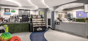 A modern coffee shop interior with a counter, menu boards, and a display case. - Two-Bedroom Condo on Daytona Beach (Daytona Beach)