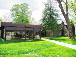 A modern building with a glass facade, a stone exterior, and a well-maintained lawn. - The Richey Suite at The Manor on Front (Harrisburg)